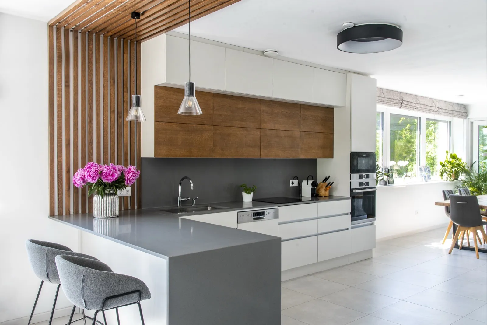 Kitchen with wood-slat ceiling divider