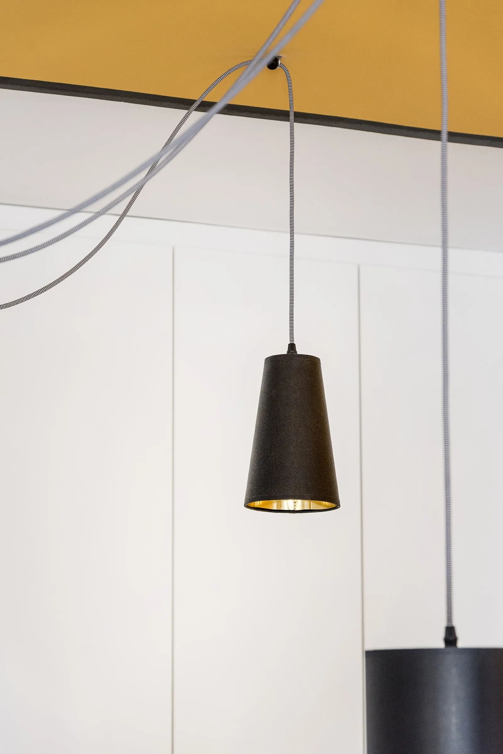 Yellow ceiling and wall with black frame